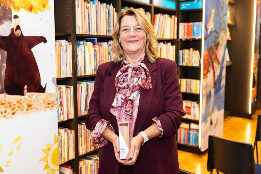 Close up of School Librarian of the year 2025 winner Julie Broadbent with her award by event photographer Adam Hollingworth 