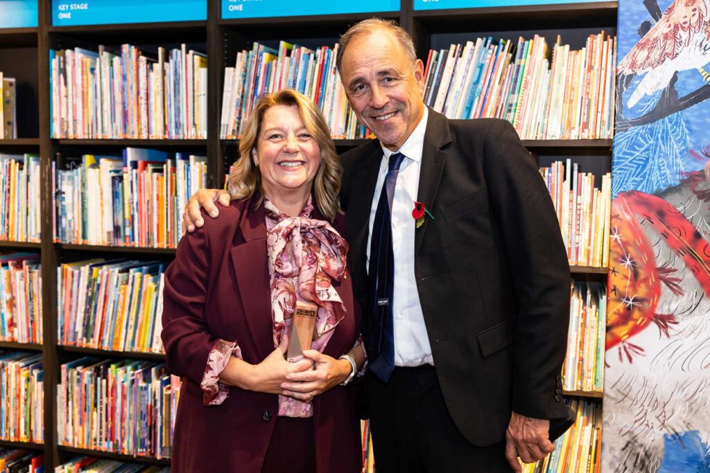 Close up of School Librarian of the year 2025 winner Julie Broadbent with her award and Anthony Horowitz by event photographer Adam Hollingworth 
